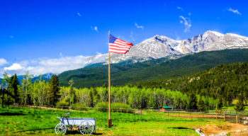 American flag and beautiful mountain landscape.